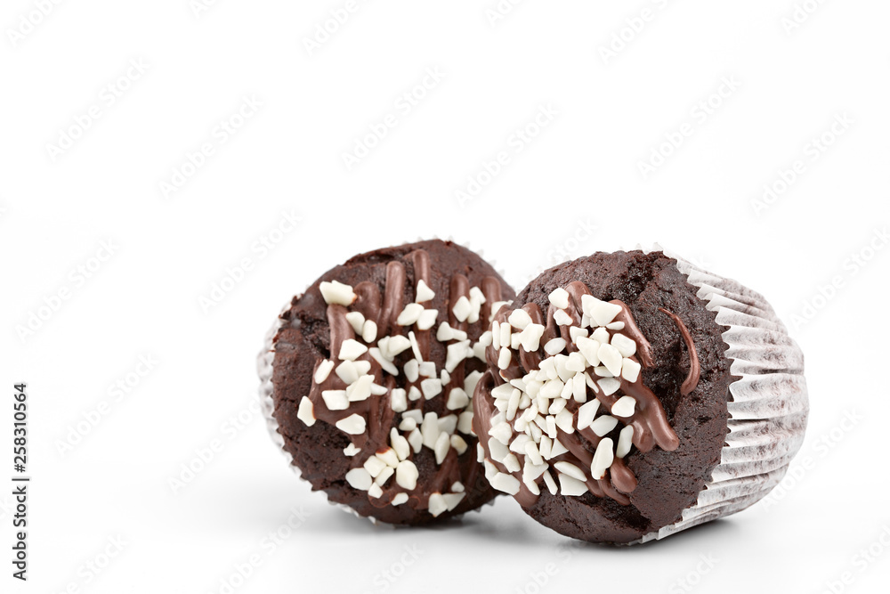 Tasty chocolate cupcakes on white background. Chocolate caramel cupcake and butterscotch syrup. Chocolate cupcake isolated on white. Tasty chocolate cupcakes on white background. Chocolate caramel cupcake and butterscotch syrup. Chocolate cupcake isolated on white.