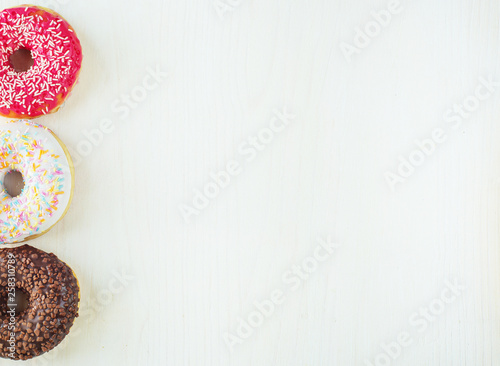 Donuts with icing on white background. Top view
