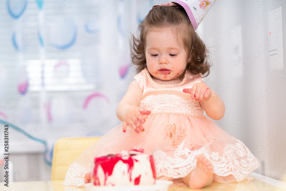 Cute sticky messy little girl eating cake Cute sticky messy little girl eating cake