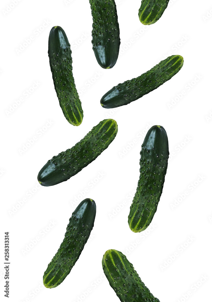 Closeup of fresh ripe green cucumber falling down on white background Closeup of fresh ripe green cucumber falling down on white background
