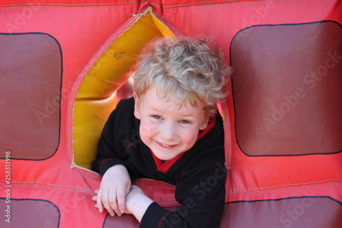 Portrait of little boy on a bouncy castle