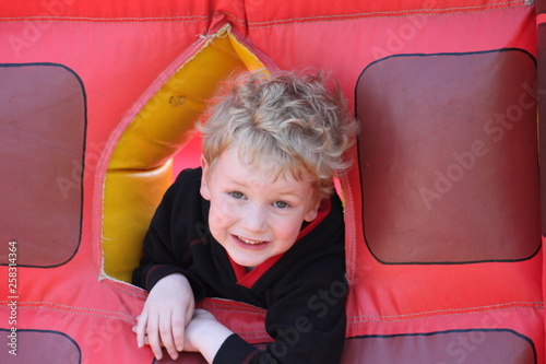 Portrait of little boy on a bouncy castle