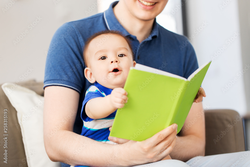 family, parenthood and people concept - happy father and little baby son with book at home family, parenthood and people concept - happy father and little baby son with book at home