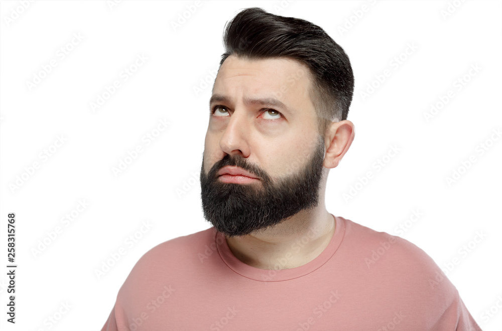A cute young bearded man in pink shirt shows emotionally happy A cute young bearded man in pink shirt shows emotionally happy