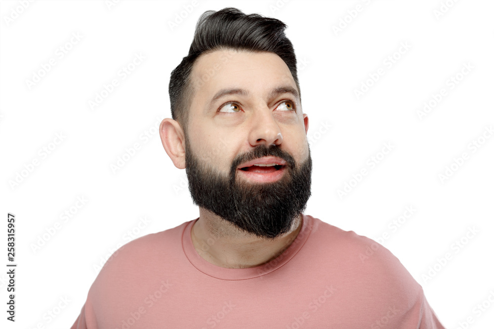 A cute young bearded man shows emotionally A cute young bearded man shows emotionally