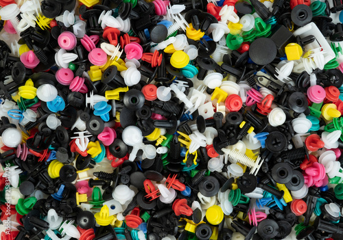 Plastic colourful mixed auto fastener. Vehicle car bumper clips retainer. Fastener rivet door panel fender liner universal Fit for All Car. Background texture