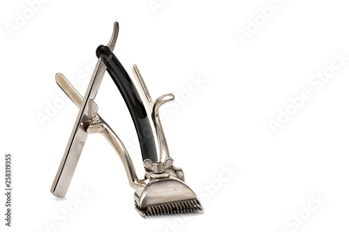 Old manual hair clipper and vintage classically straight razor isolated on white background. Barbershop tools