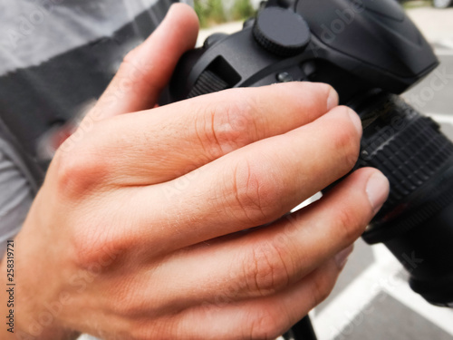Close up of human hand man using digital camera