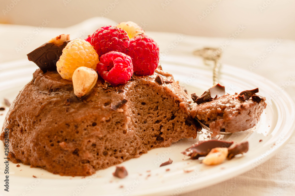 Chocolate mousse with raspberries.The process of eating.