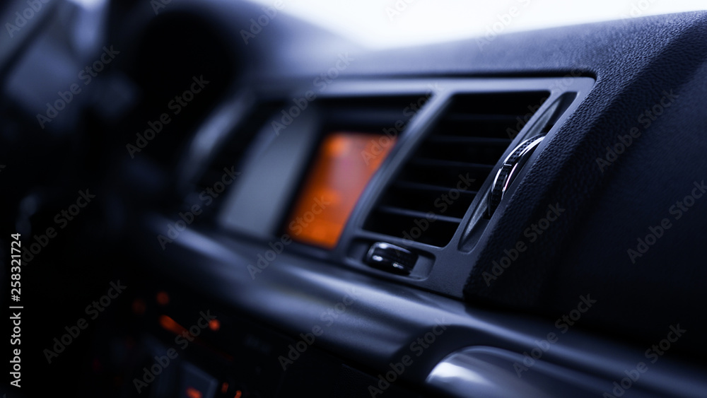 Buttons of radio, dashboard, climate control in car close up - black and orange Buttons of radio, dashboard, climate control in car close up - black and orange