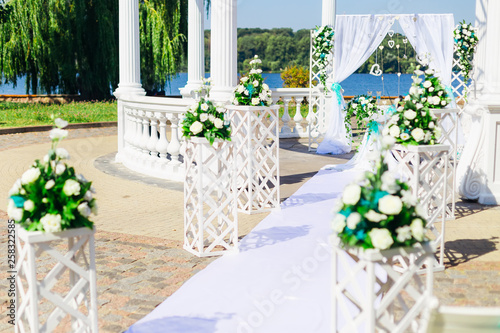 arch for the wedding ceremony in the park. wooden stands and bou