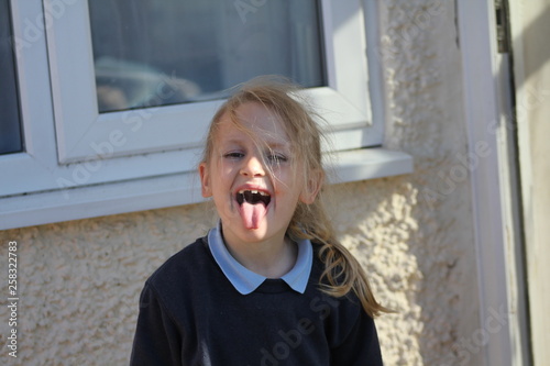 portrait of a little girl with tounge out