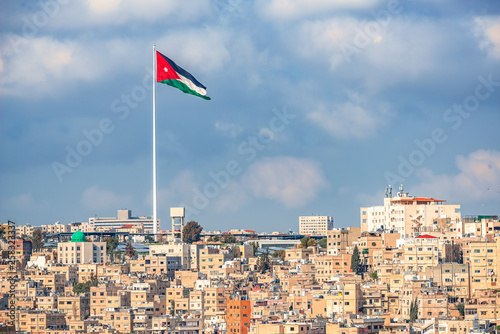 02/18/2019 Amman, Jordan, the flag of Jordan on the background of the gloomy sky walks in the wind above the capitals of the capital of the Middle Eastern state photo