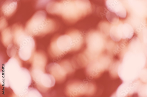 Abstract bokeh living coral color background. Place for text. Blur and festive concept. Color of the year 2019.