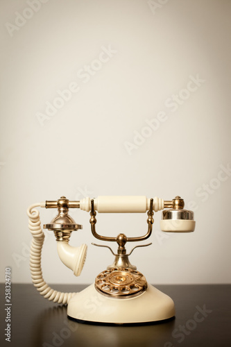 Fancy Old Vintage Telephone Isolated on a Table - Room for Text