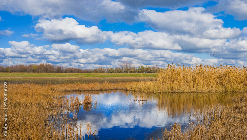 small blue lake among a prairie