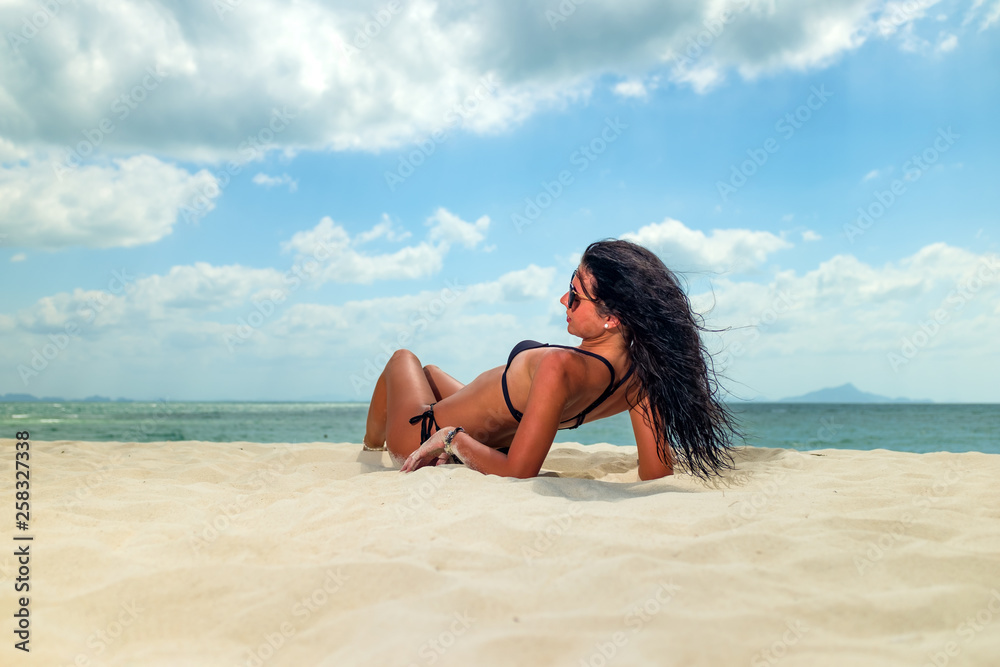 Woman enjoying her holidays on a transat at the tropical beach