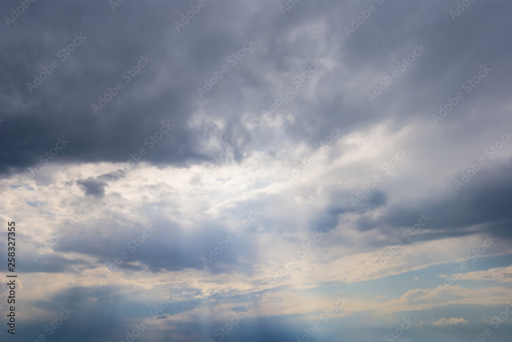 sun rays push through the dense clouds