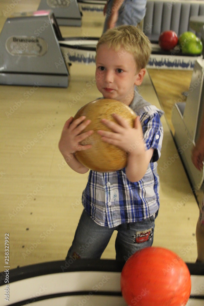 Fototapeta premium little boy with a bowling ball