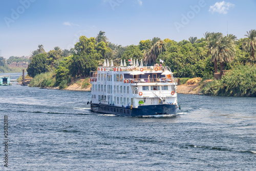  A Tourist boat motor down the River Nile towards Aswan in central Egypt. The tourist boats cruise between Luxor and Aswan in Upper Egypt