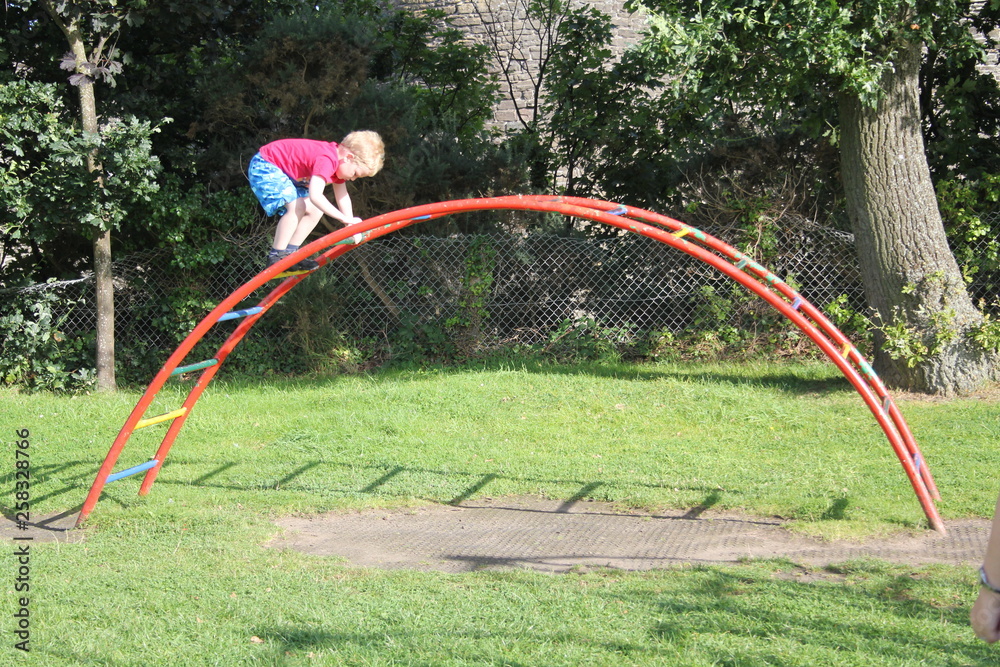 Little boy on the climbing frame Little boy on the climbing frame