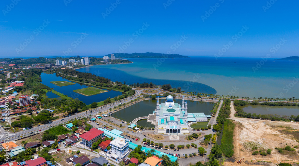 A mosque facing sea with clear blue sky 