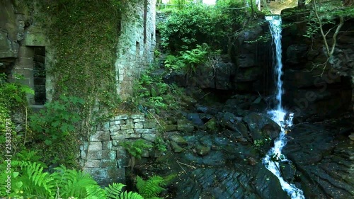 Waterfall and stone ruins of the 17th century mill. Lumsdale, Derbyshire, England. photo
