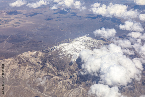 view of the snowy mountain landscape from an airplane