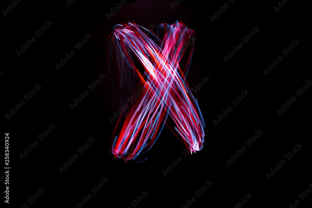 Light painting of continuous red and white spirals forming an X shape