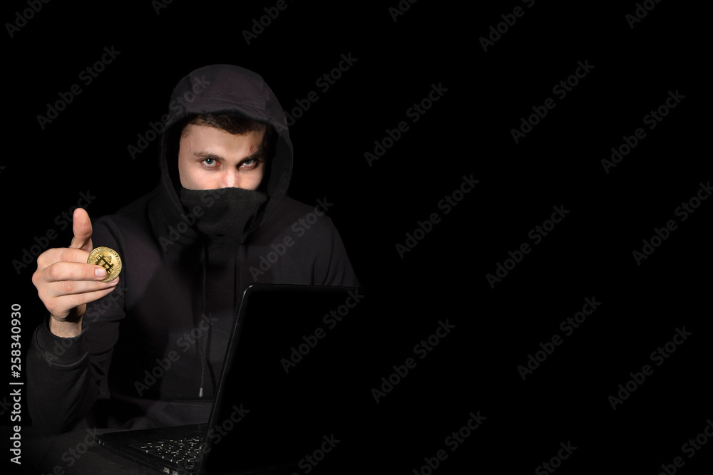 Hacker with laptop and bitcoin initiating cyber attack, isolated on black Hacker with laptop and bitcoin initiating cyber attack, isolated on black