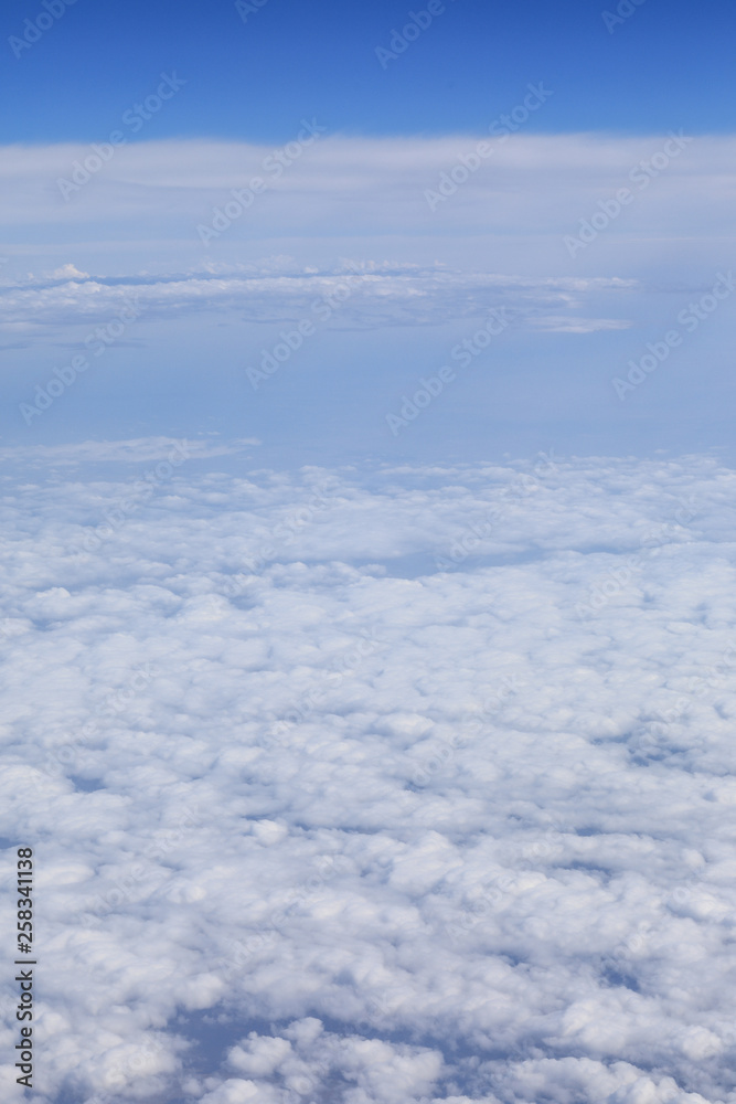 white clouds in a blue dramatic sky with a view from the plane white clouds in a blue dramatic sky with a view from the plane