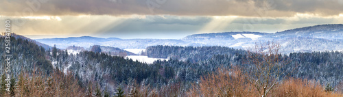 Panorama of the winter landscape in the Bavarian Forest in Bavaria, Germany, in dramatic evening light.