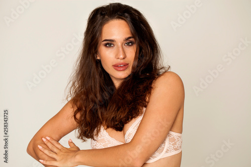 Young brunette woman in white underwear, studio