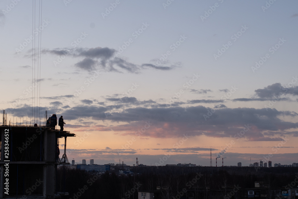 Fototapeta premium Construction crane on the construction site. Under construction concrete building.