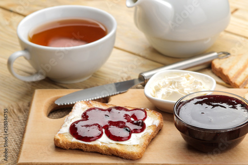toasts with jam. fried crispy toast with red jam on a natural wooden table. breakfast.