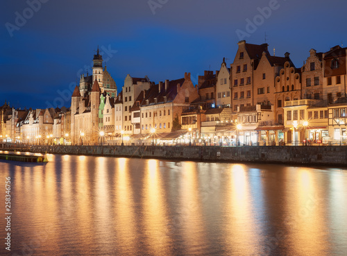 Old town in Gdansk, Poland, at night. Promenade and city light reflections.
