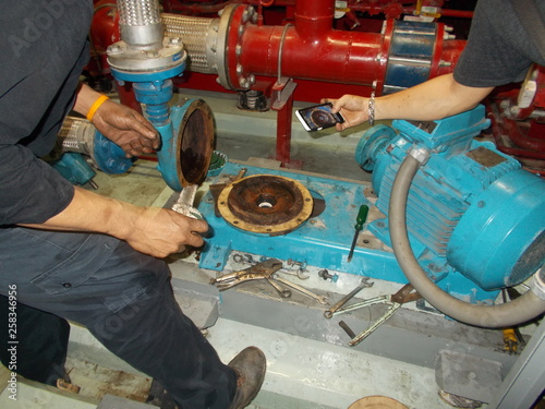 Maintenance Water Pump for Sanitary System.Technician is taking photo.