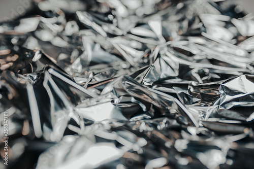 Silver rumpled foil. Gray background with texture