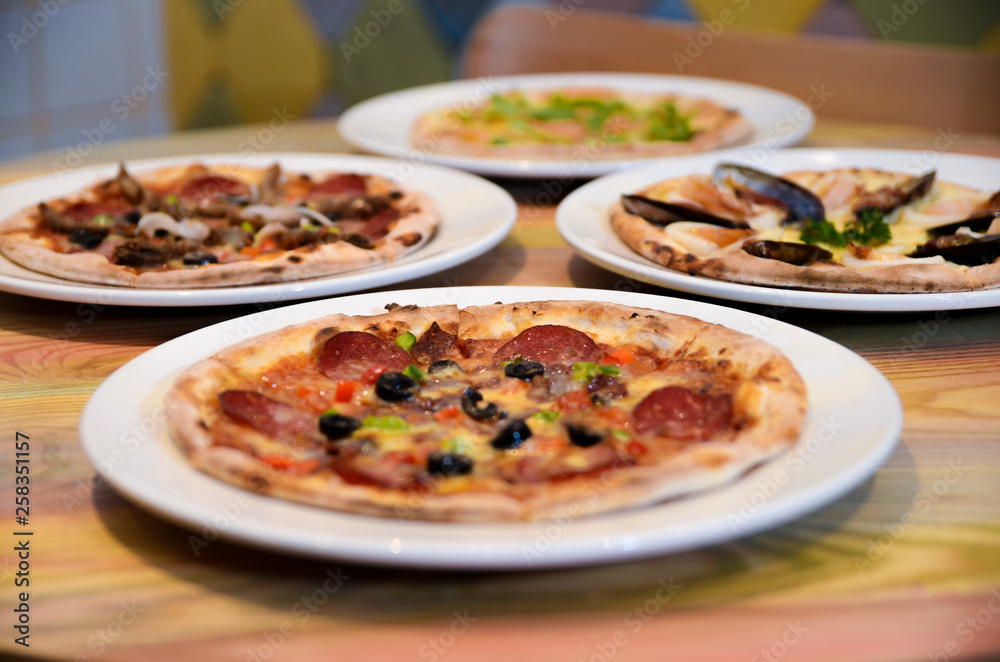 Slice of hot pizza cheese lunch or dinner crust seafood meat topping sauce with bell pepper vegetables delicious tasty fast food italian traditional on wooden board table classic with delivery hand 