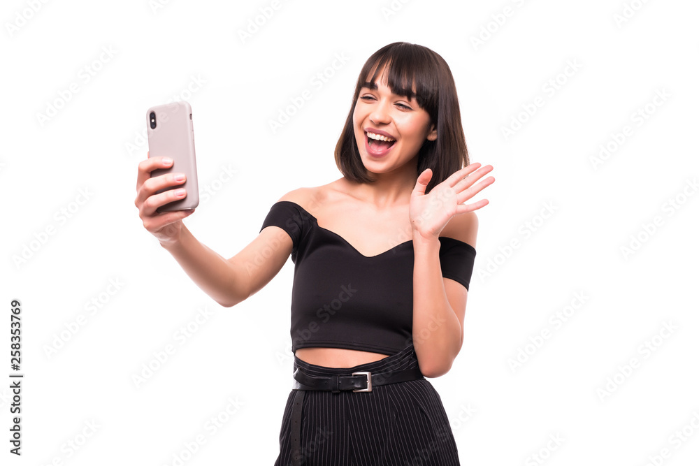 Happy woman chatting via video call and greeting with hand isolated on a white background Happy woman chatting via video call and greeting with hand isolated on a white background