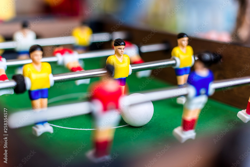 Children playing a colorful table football game Children playing a colorful table football game