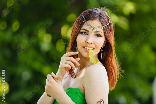 Wallpaper Mural Beautiful young asian woman with a peel of fresh kiwi in hands Torontodigital.ca