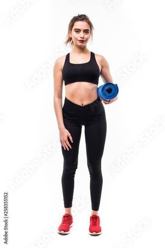 Young attractive woman holding a yoga mat isolated on white background