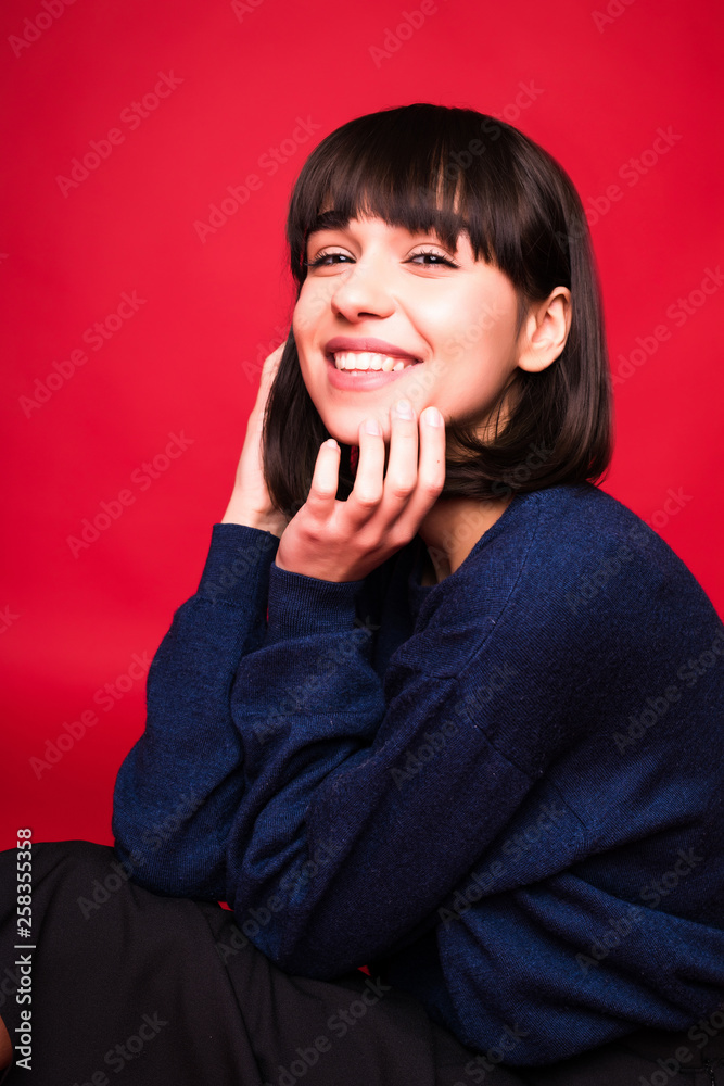 Young pretty brunette woman portrait isolated on red background Young pretty brunette woman portrait isolated on red background