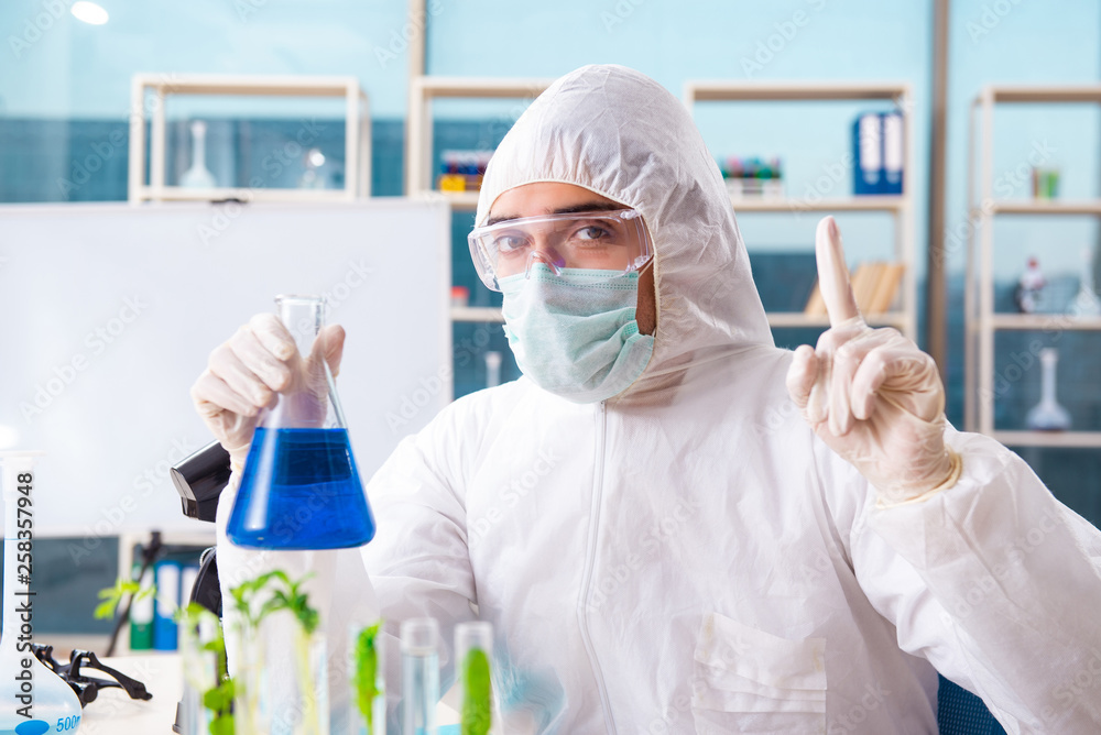 Male biotechnology scientist chemist working in the lab Male biotechnology scientist chemist working in the lab