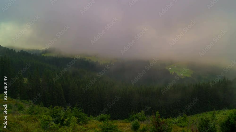 The Mountain Forest on Background of Sunset. Dramatic Sunset Sky with Dark Clouds and Fog. Timelapse. 4K. The Mountain Forest on Background of Sunset. Dramatic Sunset Sky with Dark Clouds and Fog. Timelapse. 4K.