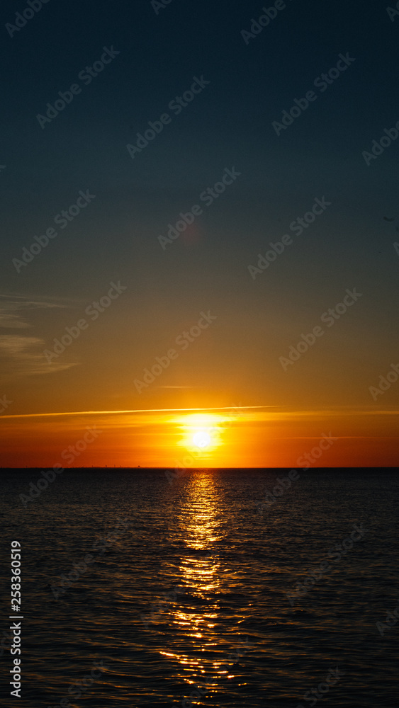 Sunset or dawn at sea. Black Sea shore. Mobile Screensaver, Vertical Layout, Nature Wallpaper. Beautiful Colors, Marine Theme Concept