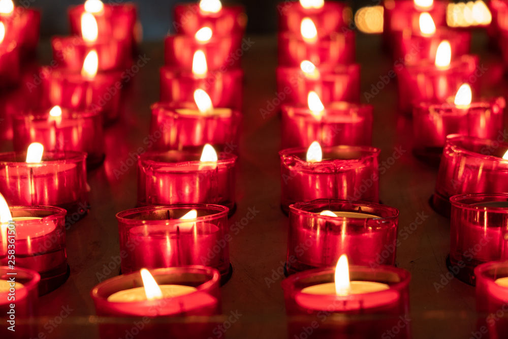 Red candles glowing in the dark. Taken in religious environment
