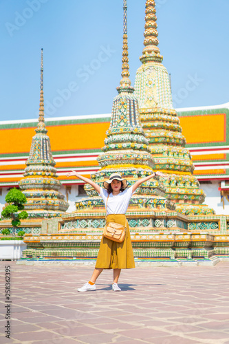Happy Asian Woman Travel at temple in Thailand