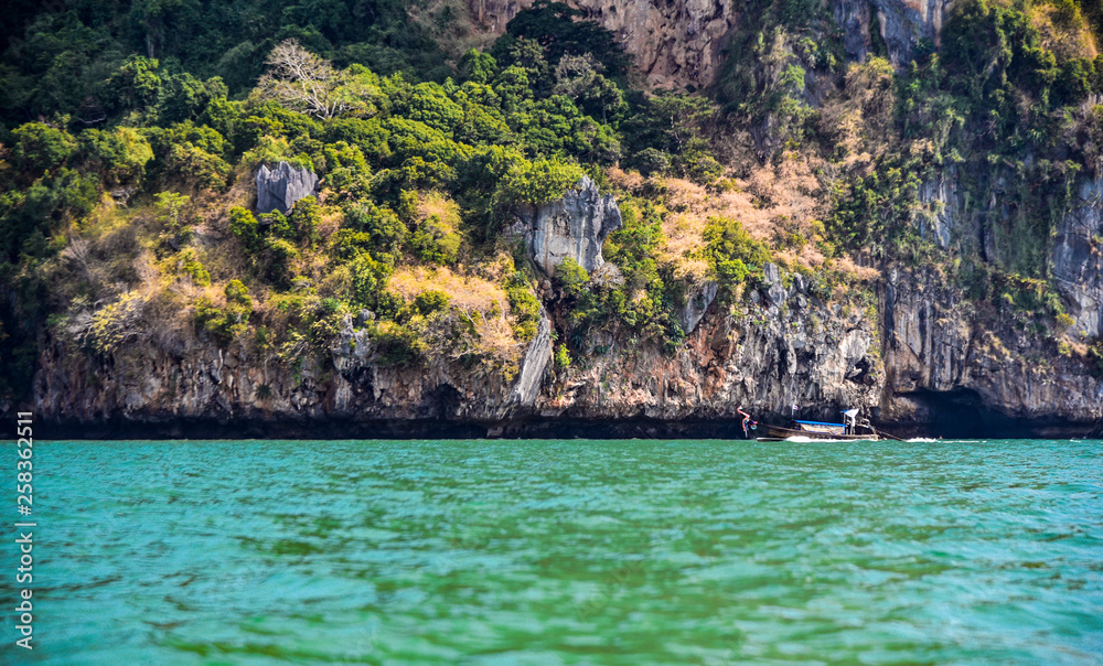 Longboats along the coastline near Railay Beach in Thailand